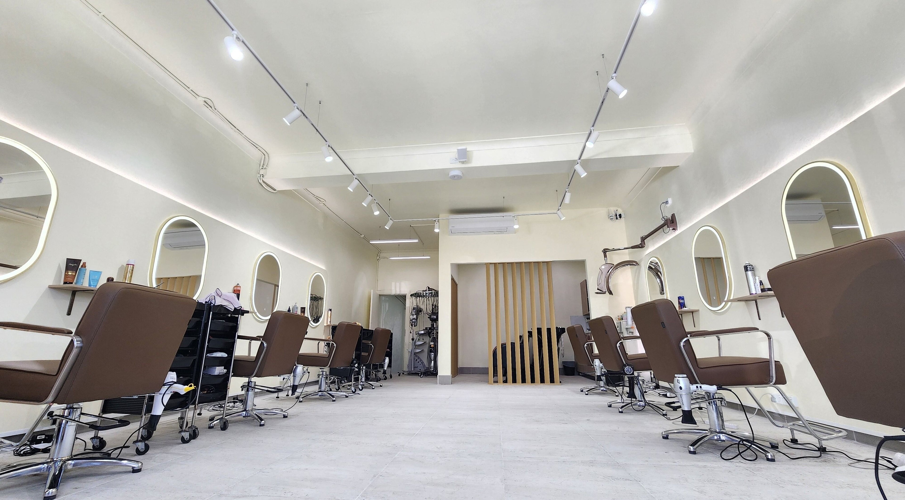 Modern salon interior at Perm Perm Hair, Lidcombe, New South Wales, AU with sleek styling chairs and mirrors.