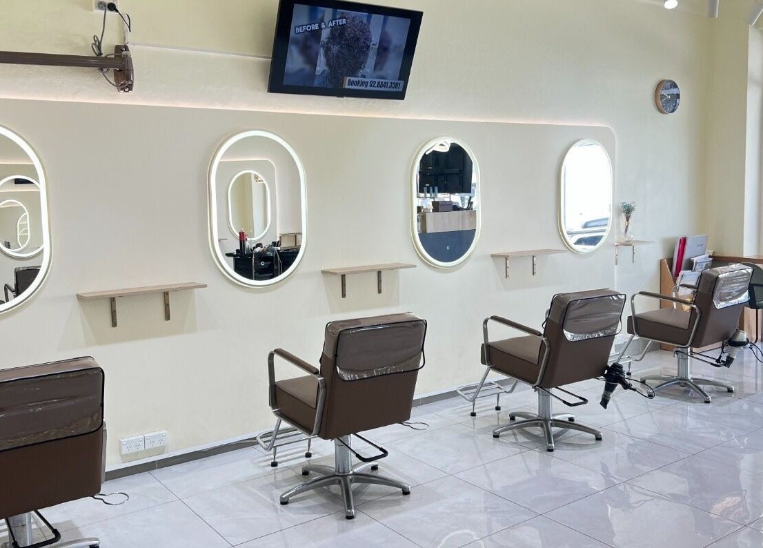 Modern salon interior at Perm Perm Hair, Lidcombe, New South Wales, AU with stylish chairs and mirrors.