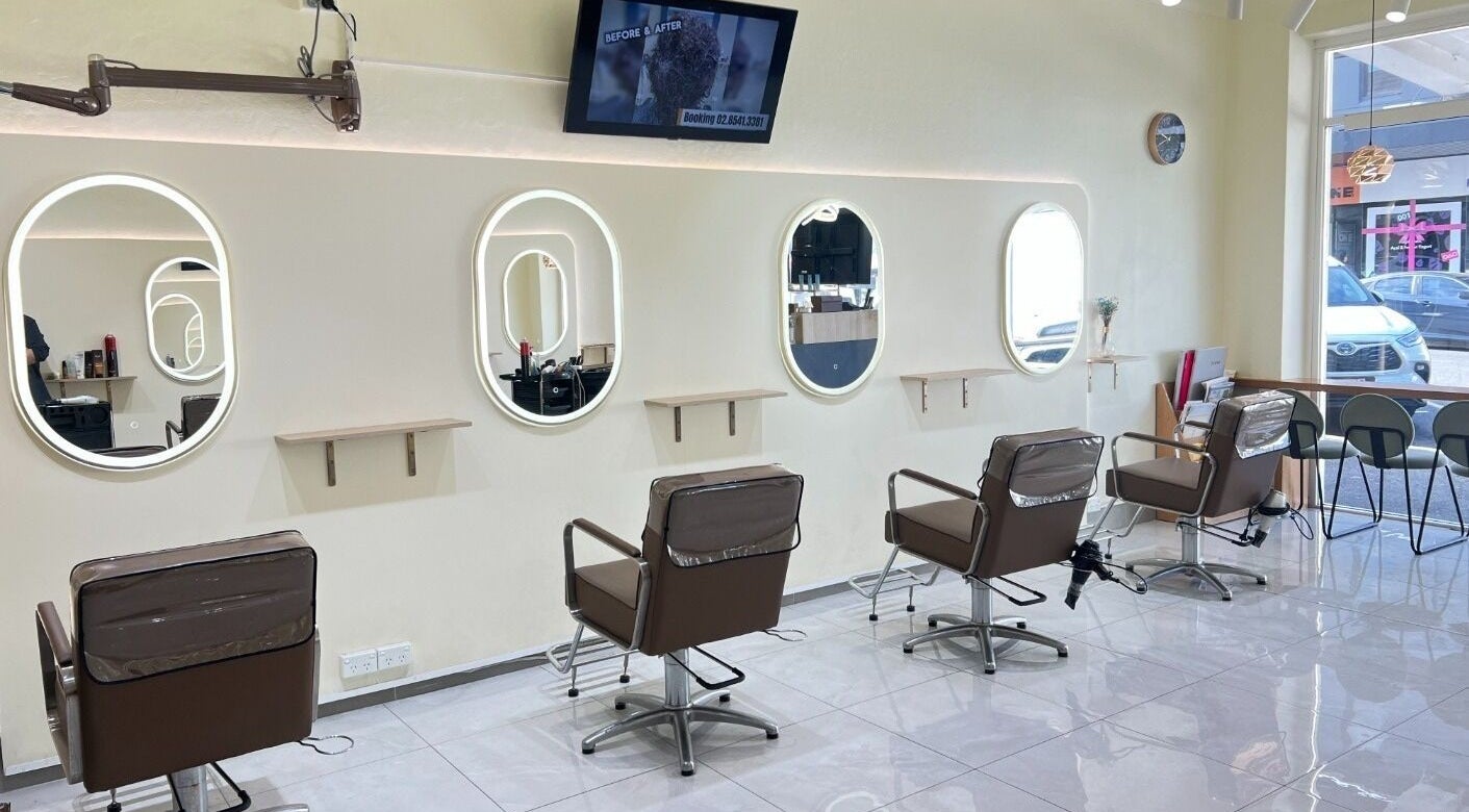 Modern salon interior at Perm Perm Hair, Lidcombe, New South Wales, AU with stylish chairs and mirrors.