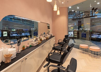 Interior of Exquisite Brows Eastgardens, New South Wales, AU, showcasing sleek chairs and beauty essentials.