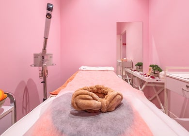 Relaxing spa room at Exquisite Brows and Spa Miranda, New South Wales, AU with pink walls and cozy treatment bed.