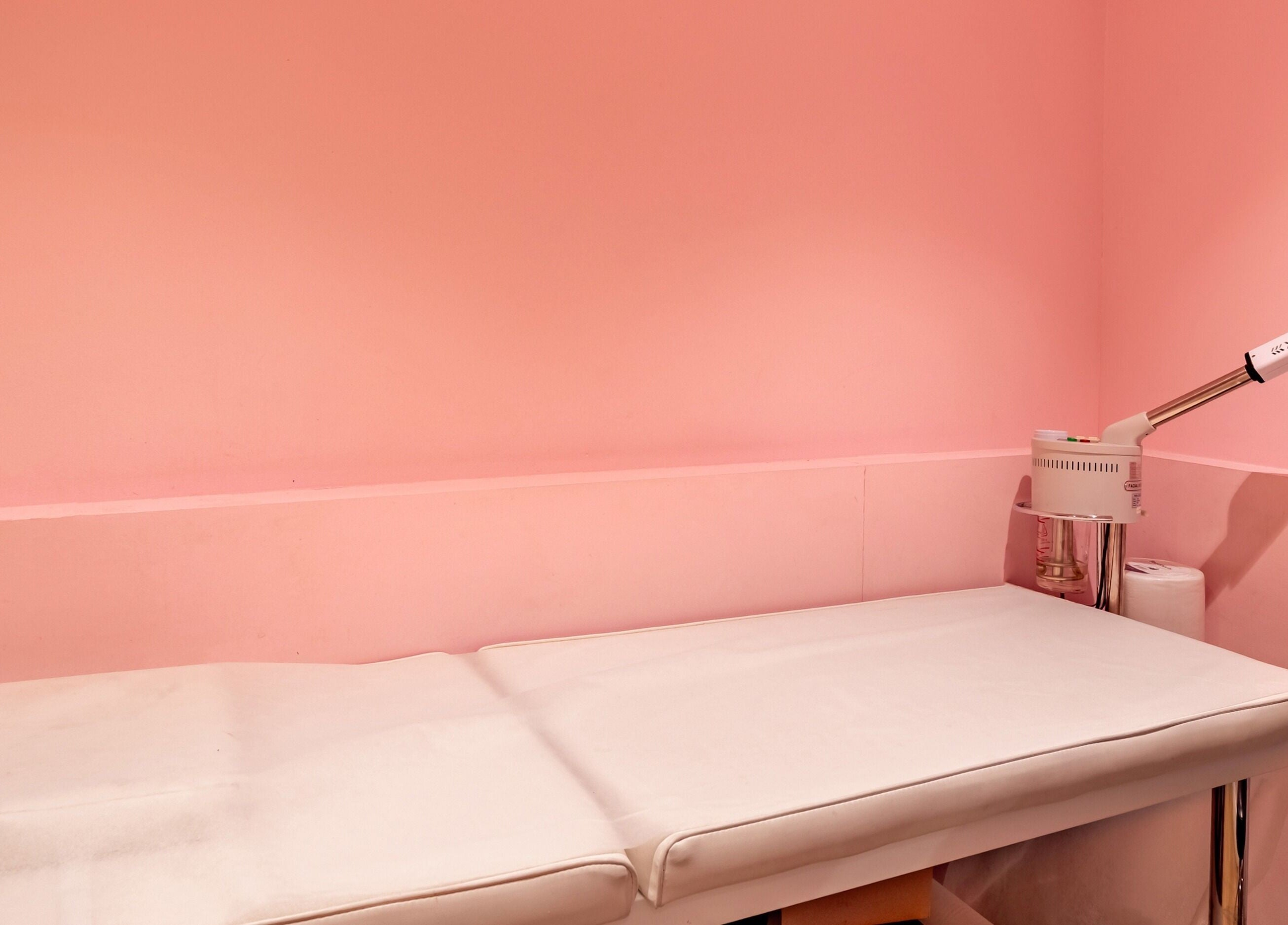 Cozy treatment room at Exquisite Brows and Spa Liverpool, New South Wales, AU with a pink ambiance.