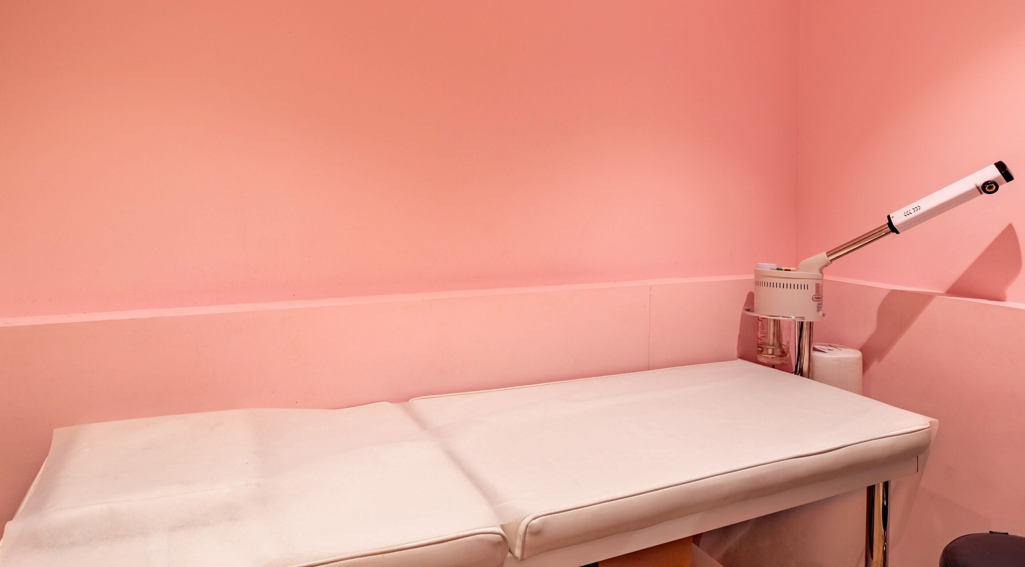 Cozy treatment room at Exquisite Brows and Spa Liverpool, New South Wales, AU with a pink ambiance.