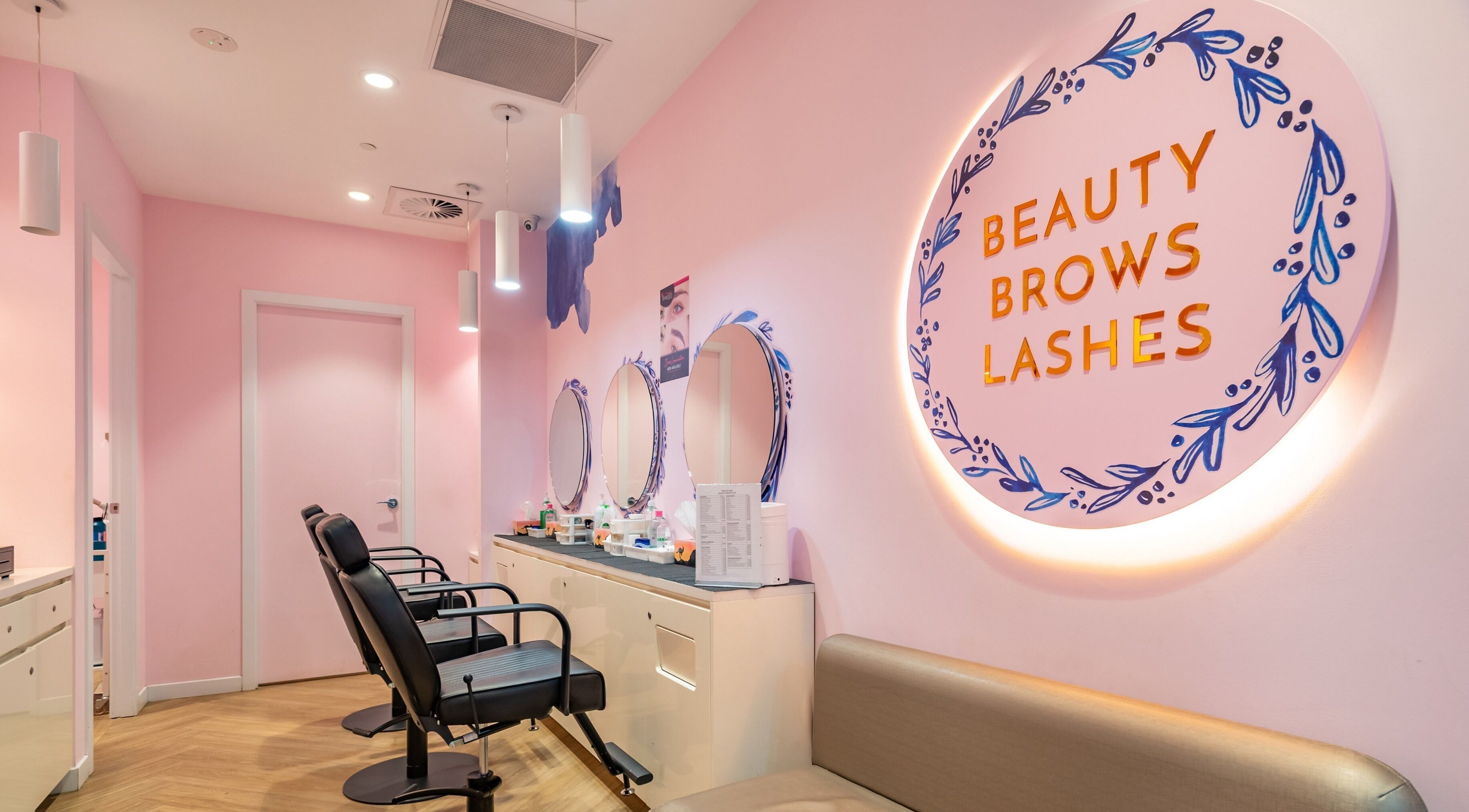9. Exquisite Brows and Spa Marrickville Metro in vibrant pink decor with salon chairs, Marrickville, New South Wales, AU.