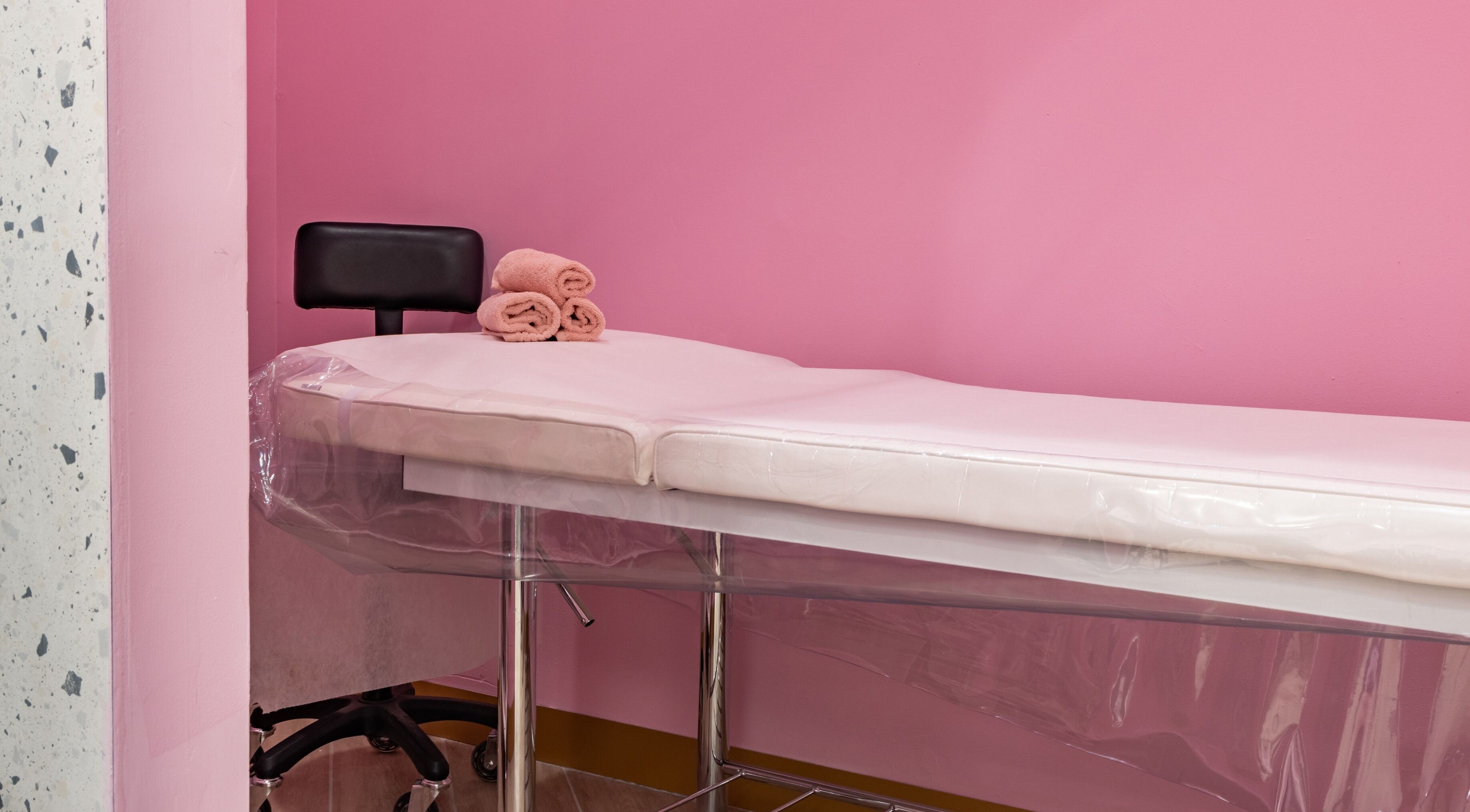 Relaxing treatment room with pink walls at Exquisite Brows And Spa Glebe, Glebe, New South Wales, AU.