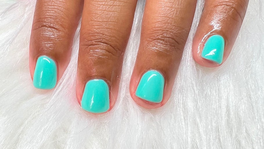 Turquoise manicure at Luxe Studio, Christ Church, BB on a plush white surface.