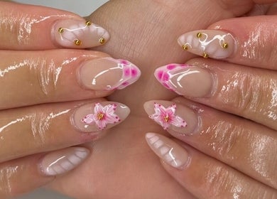 Elegant floral nail art by Nailzbybrenisbel, Rockville, Maryland, US. Intricate pink designs with shiny finish.