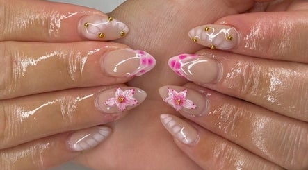 Elegant floral nail art by Nailzbybrenisbel, Rockville, Maryland, US. Intricate pink designs with shiny finish.