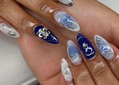 Chic blue and white nail designs at Nailzbybrenisbel, Rockville, Maryland, US, showcasing intricate art.
