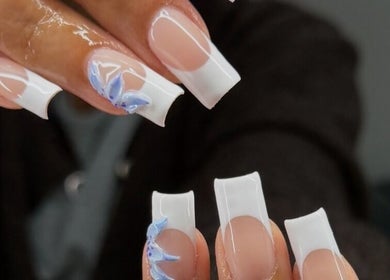 Chic French manicure with blue flower at Nailzbybrenisbel, Rockville, Maryland, US.