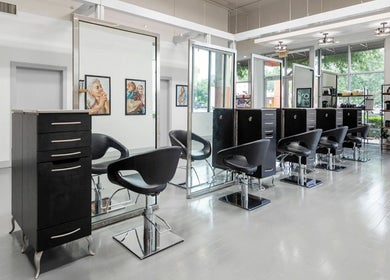 Modern salon interior at Mark Yared Hair Stylist, Austin, Texas, US, featuring stylish chairs and large mirrors.