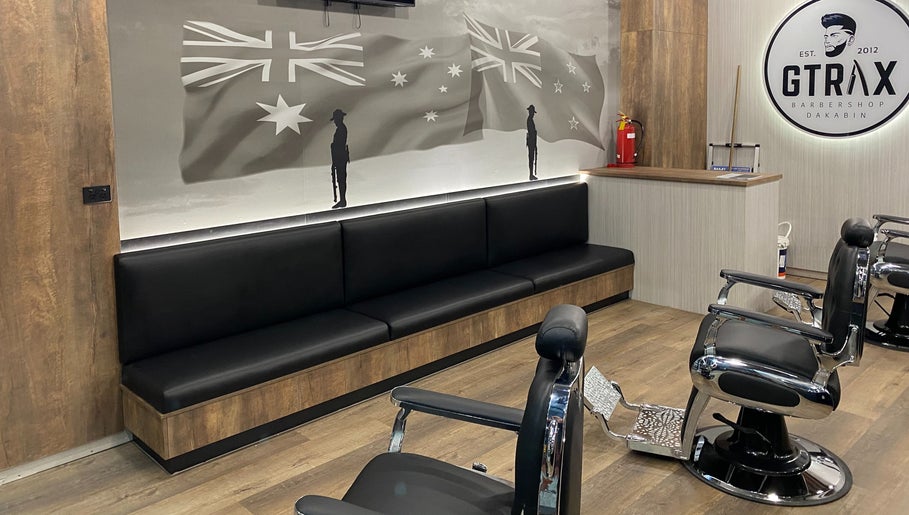 Modern interior of Gtrax Barbershop in Dakabin, Queensland, AU with stylish chairs and sleek decor.