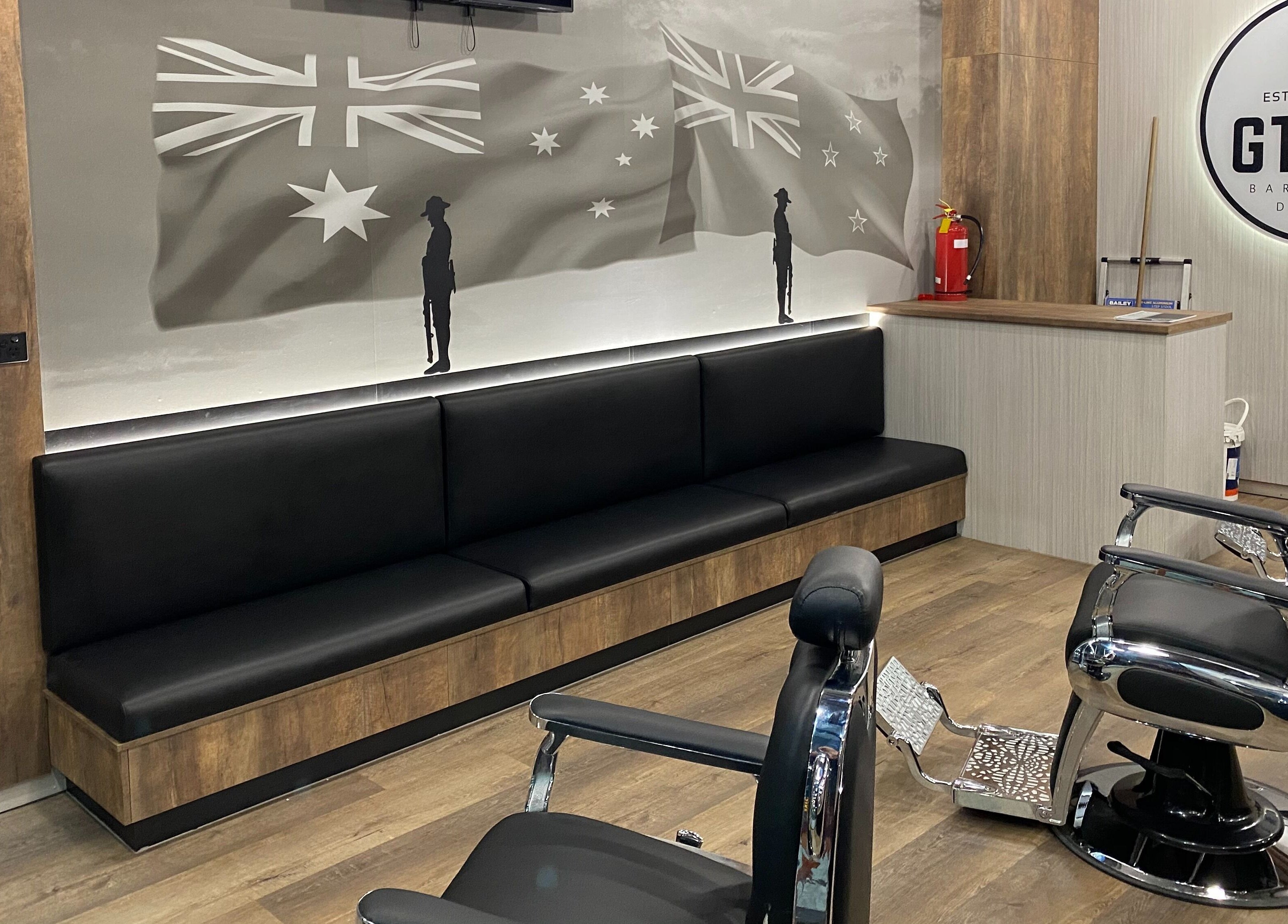 Modern interior of Gtrax Barbershop in Dakabin, Queensland, AU with stylish chairs and sleek decor.