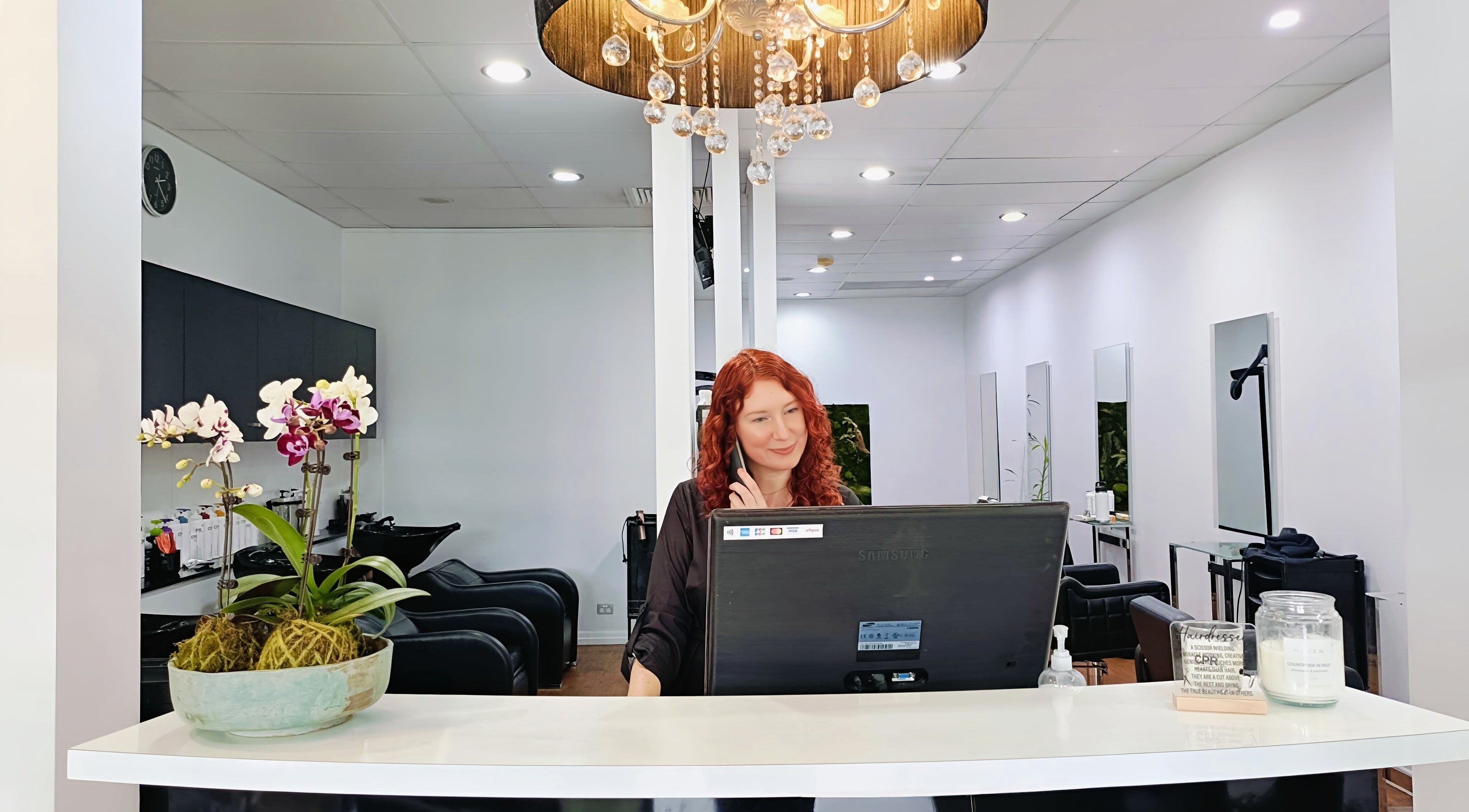Reception area at Imaj For Hair, Gympie QLD with a welcoming staff member at the desk.