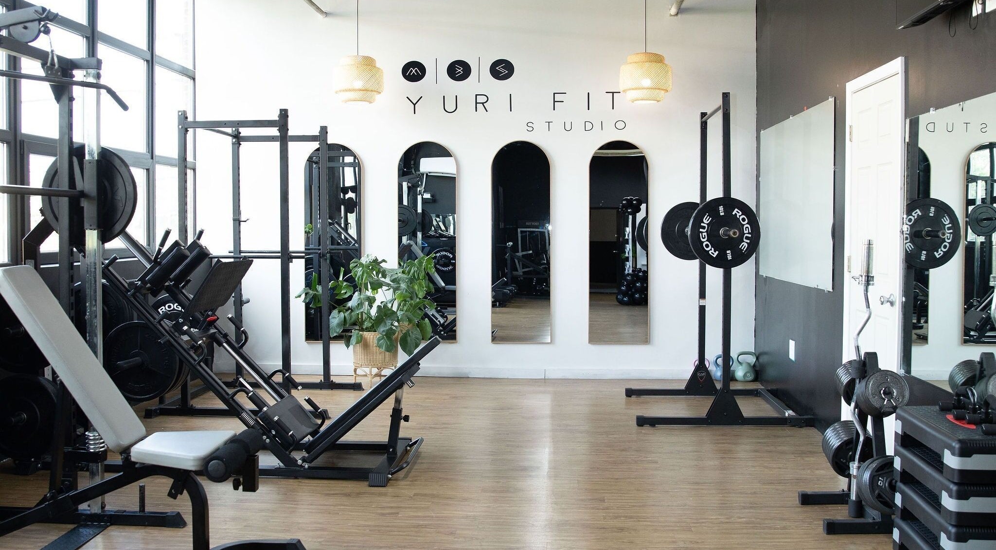 Modern gym setup at Yuri Fit Studio in Philadelphia, Pennsylvania, US, showcasing advanced fitness equipment.