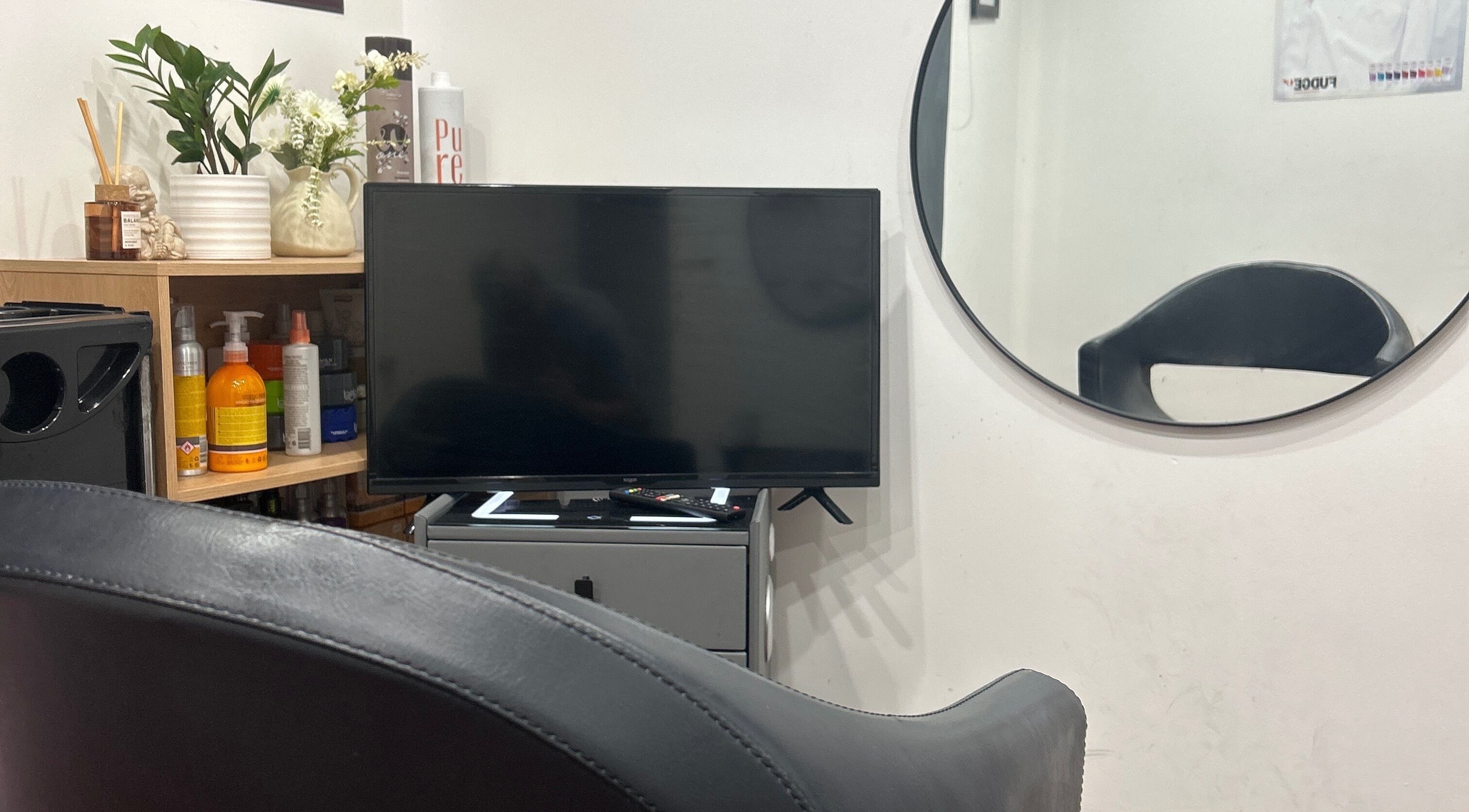 Mohit hairdresser seating area with TV and decor, Gosnells, Western Australia, AU.