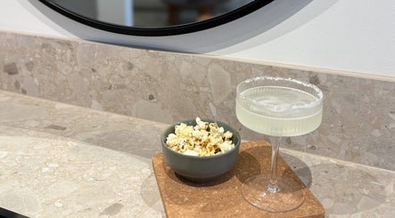 Cocktail and popcorn at Hair with Amiee, Manoora, Queensland, AU, creating a stylish ambiance.