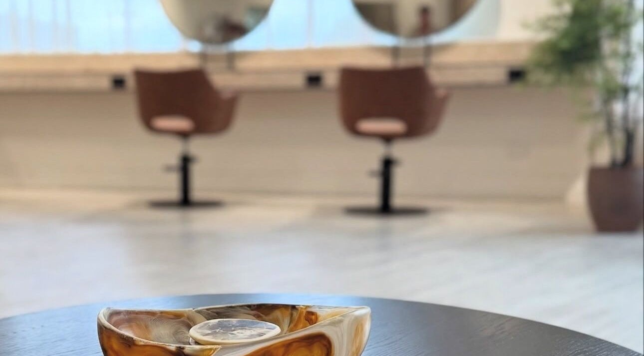 Elegant interior of Hair with Amiee salon in Manoora, Queensland, AU, featuring modern decor and comfortable seating.