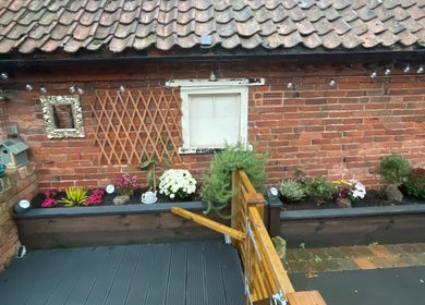Charming garden exterior at Eagle House Salon, Southwell, England, GB, featuring vibrant flowers and rustic decor.