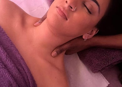 Relaxing massage session at SIESTA7, Nottingham, England, GB. A woman enjoys soothing neck treatment.