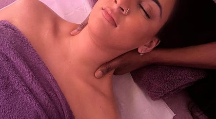 Relaxing massage session at SIESTA7, Nottingham, England, GB. A woman enjoys soothing neck treatment.