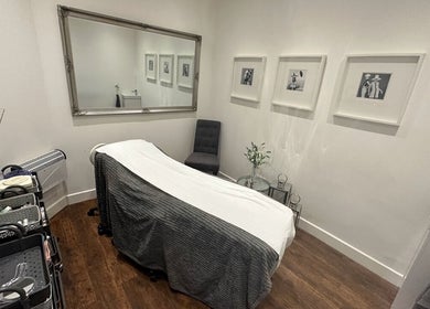 A serene treatment room at PAB in Newcastle upon Tyne, England, GB, featuring a massage bed and elegant decor.