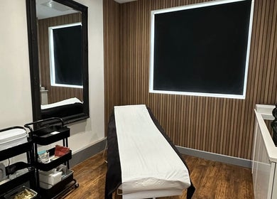Tranquil treatment room at PAB, Newcastle upon Tyne, England, GB featuring a massage bed and modern decor.