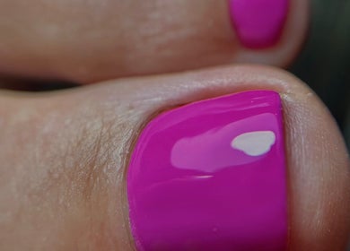 Close-up of vibrant pink toenail polish at Studio Giulia, Zürich, CH. Perfect nail care.