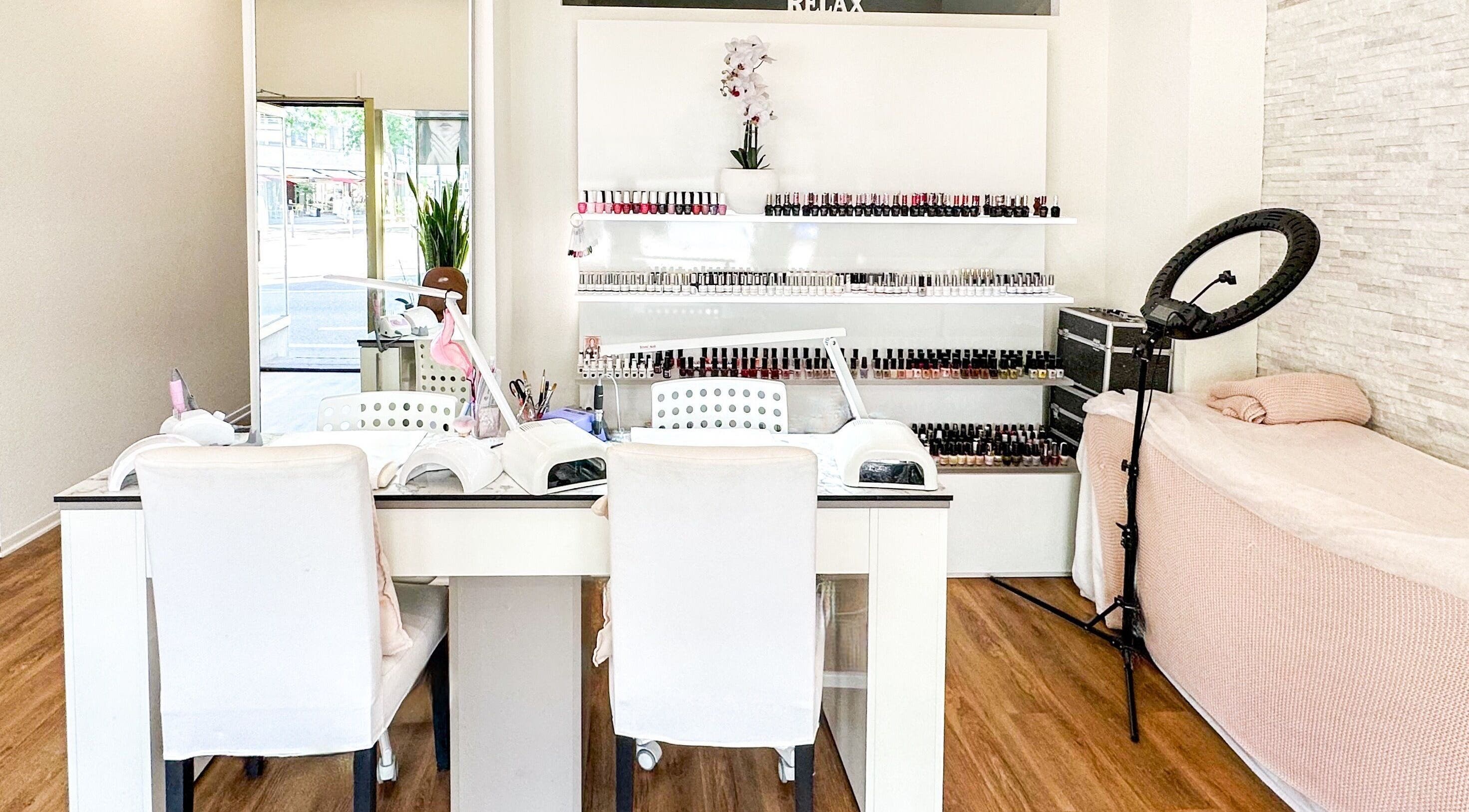 Chic interior of STUDIO GIULIA, Zürich, CH, showcasing a modern nail beauty space with nail polish display.