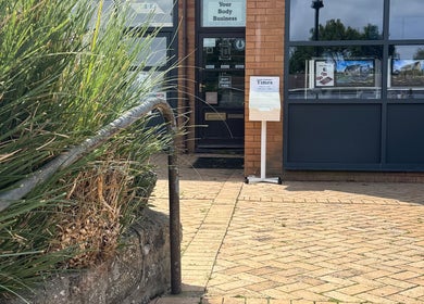 Entrance of Amanda's Laser Clinic, Yatton, England, GB with inviting signage and greenery.