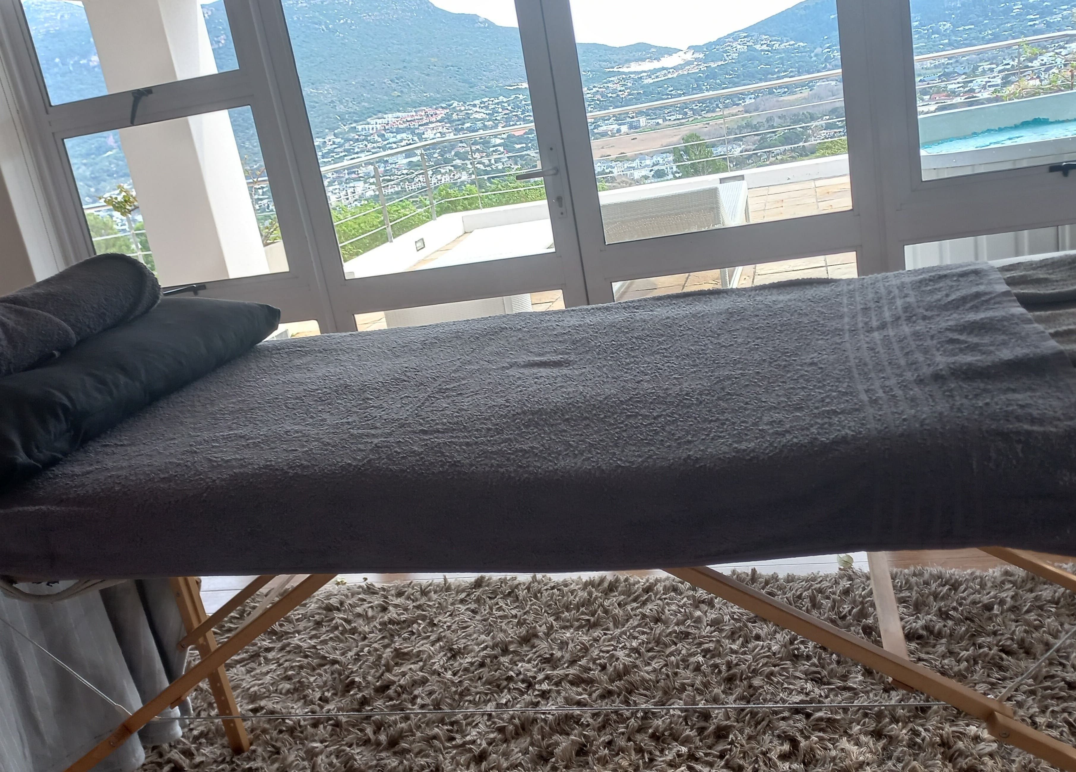 Massage table overlooking stunning view at CAPE TOWN TRAVELLING THERAPIST, Cape Town, Western Cape, ZA.