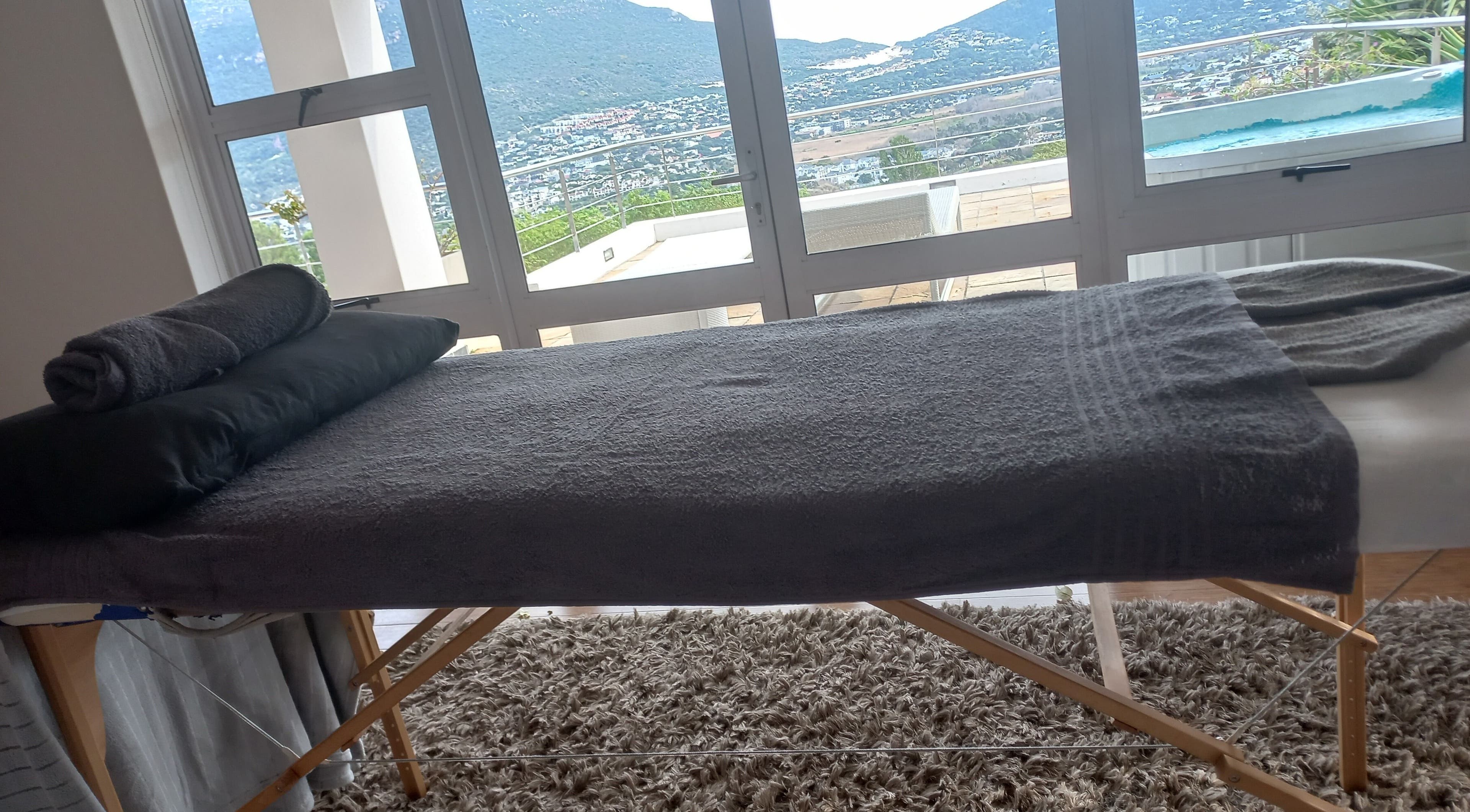 Massage table overlooking stunning view at CAPE TOWN TRAVELLING THERAPIST, Cape Town, Western Cape, ZA.
