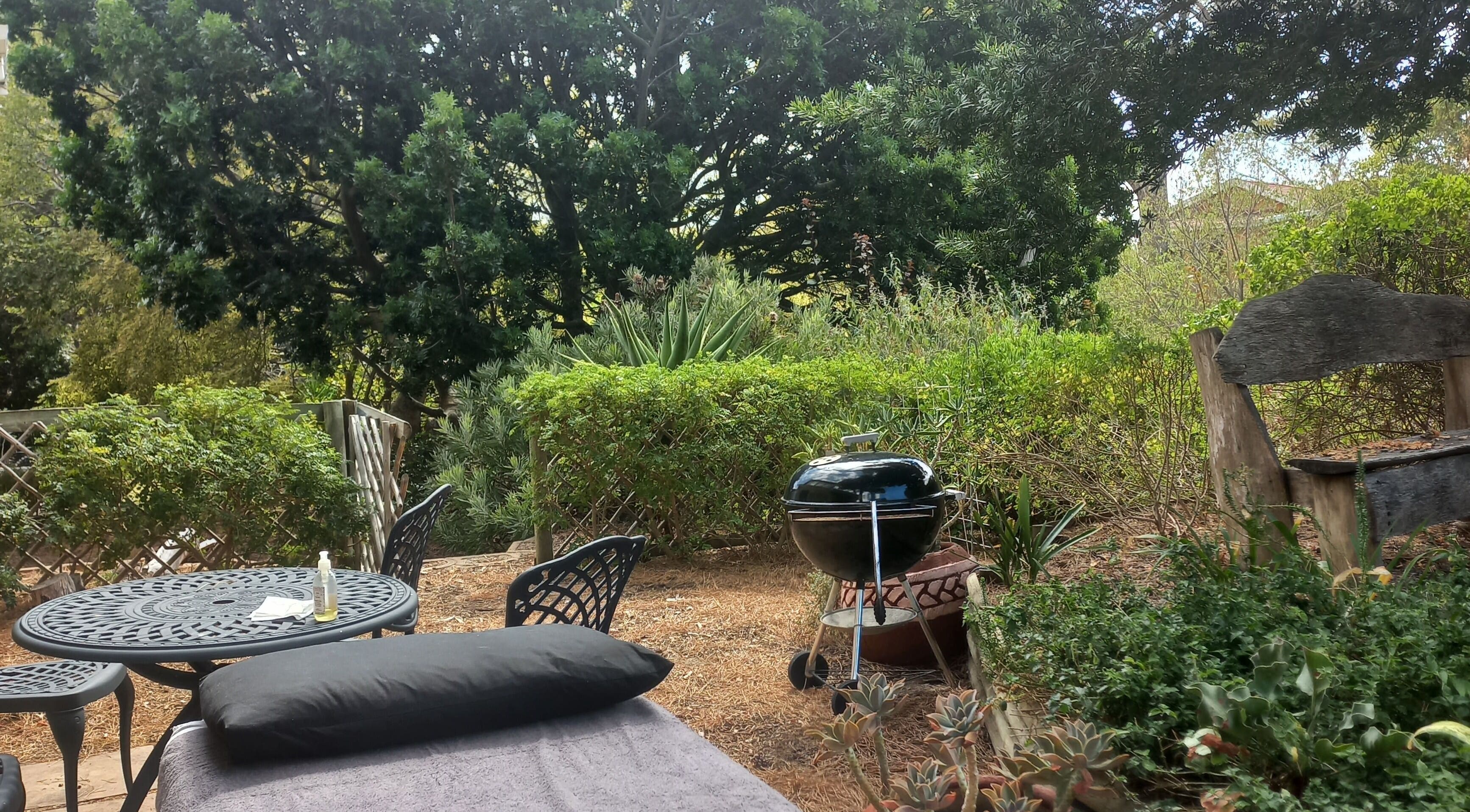 Outdoor relaxation area at CAPE TOWN TRAVELLING THERAPIST in Cape Town, Western Cape, ZA with lush greenery.