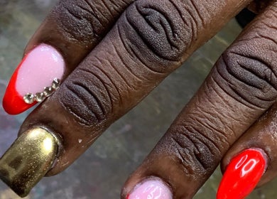 Stylishly manicured nails at Pinkprincesses&Co, Ellerton, Saint George, BB with red, gold, and gem designs.