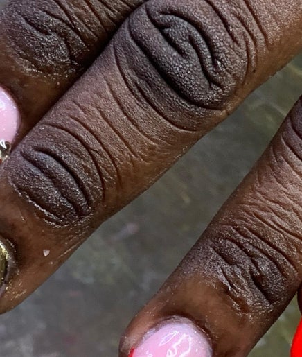 Stylishly manicured nails at Pinkprincesses&Co, Ellerton, Saint George, BB with red, gold, and gem designs.