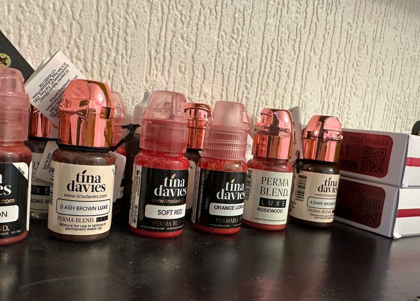 Colorful cosmetic pigment bottles on a shelf at Studio 88 in Cardiff, Wales, GB, ideal for beauty treatments.