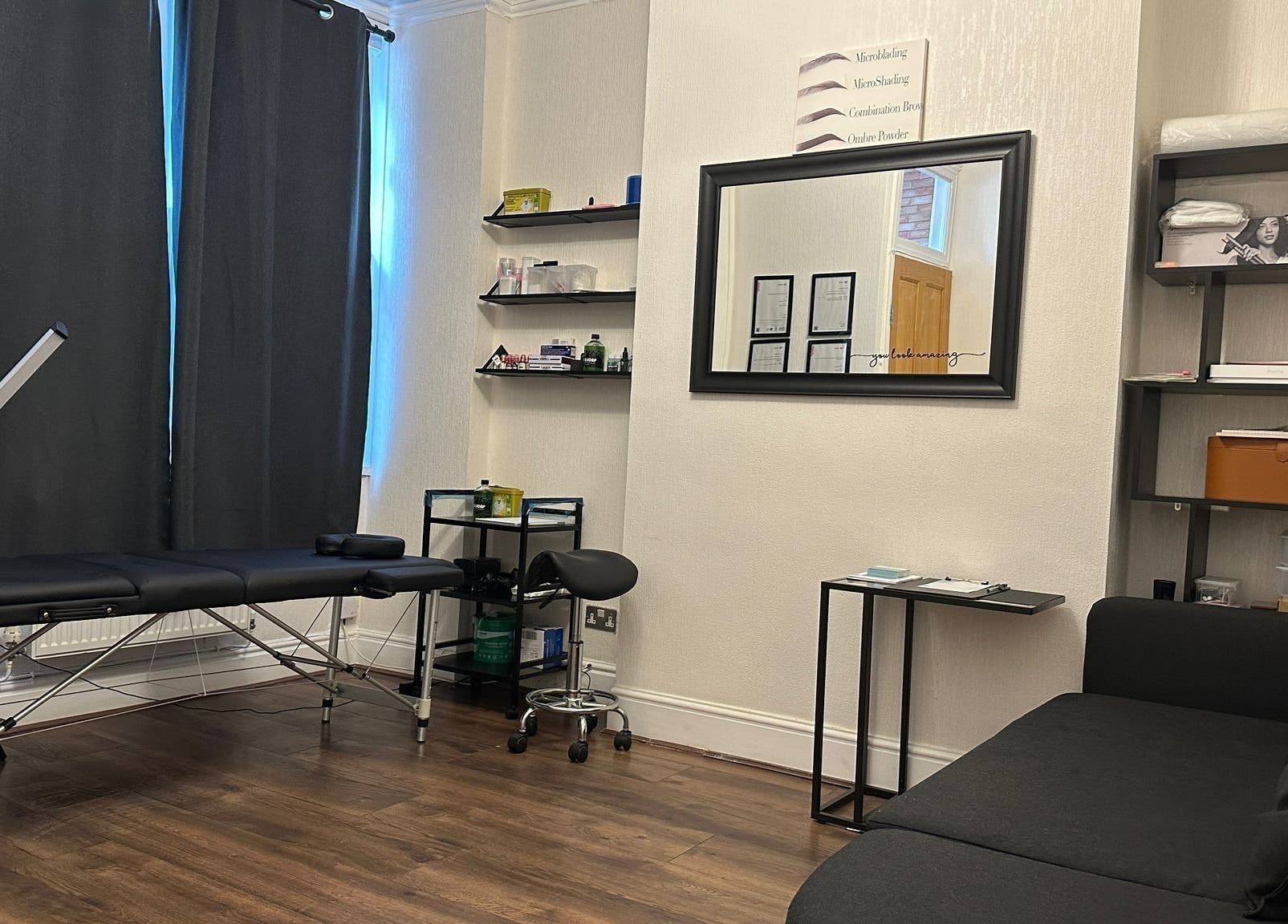 Calming therapy room at Studio 88, Cardiff, Wales, GB with massage bed and modern decor.