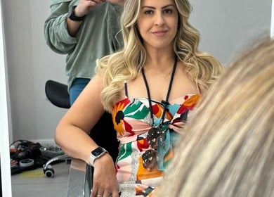 Woman with styled hair at Fernanda in GB beauty salon, enjoying a glam session.