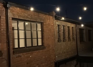 Kluxr Aesthetics exterior with string lights in Birmingham, England, GB.