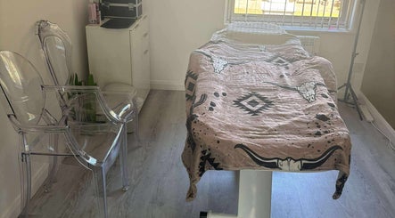 Calm treatment room at TJ Nails & Beauty in Ripley, England, GB featuring a comfy massage bed and modern decor.