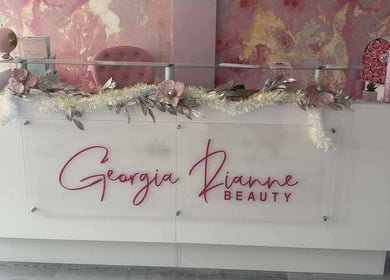 Chic reception area at TJ Nails & Beauty, Ripley, England, GB featuring a white desk with decorative floral accents.