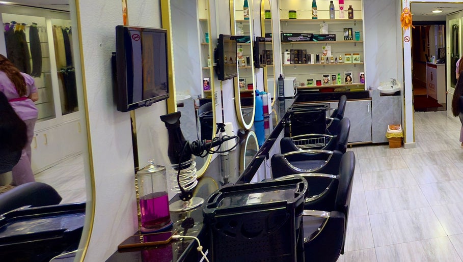 Modern salon interior at GIGI BEAUTY CENTER, Dubai, Dubai, AE, featuring sleek black chairs and product displays.