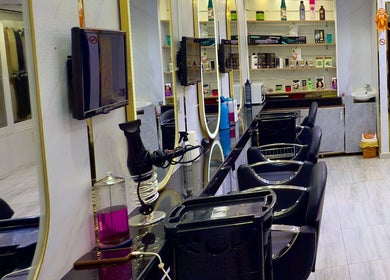 Modern salon interior at GIGI BEAUTY CENTER, Dubai, Dubai, AE, featuring sleek black chairs and product displays.