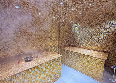 Luxurious steam room with golden tiles at GIGI BEAUTY CENTER, Dubai, Dubai, AE offering a serene experience.