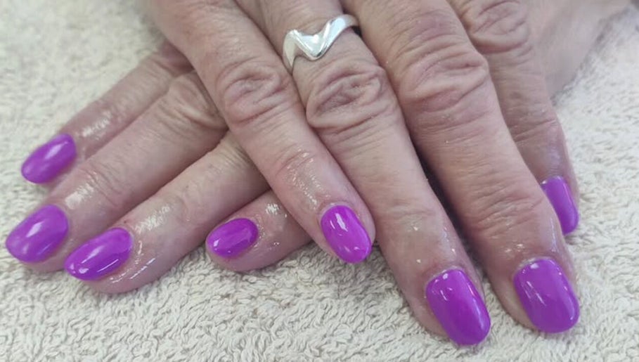 Vibrant purple manicured nails at Cassie's Beauty Therapy, Bude, England, GB, showcasing professional nail art.