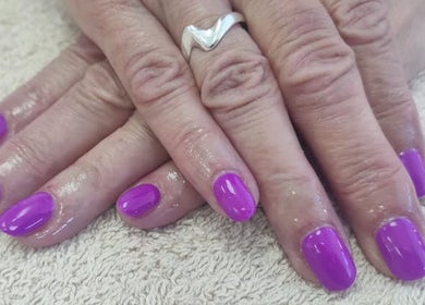 Vibrant purple manicured nails at Cassie's Beauty Therapy, Bude, England, GB, showcasing professional nail art.