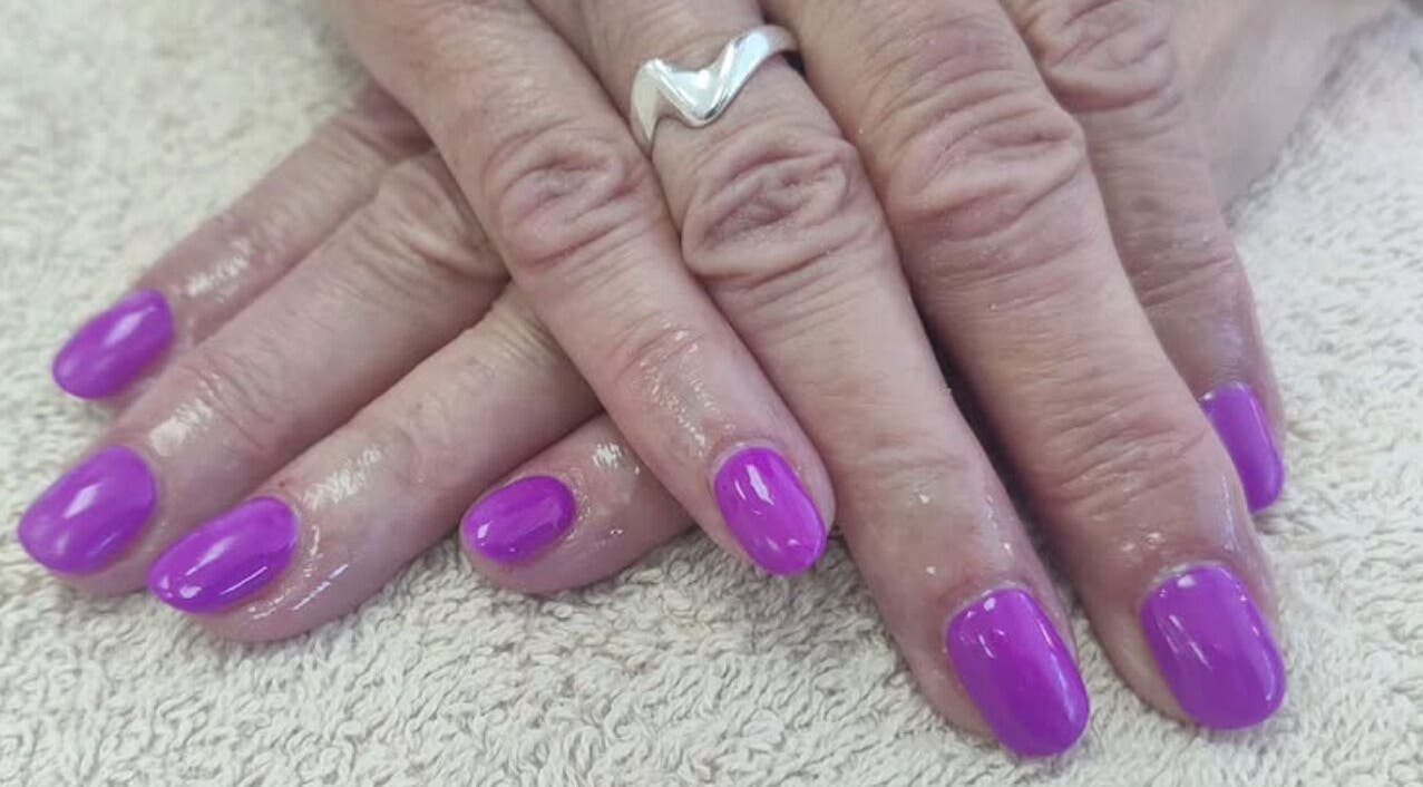 Vibrant purple manicured nails at Cassie's Beauty Therapy, Bude, England, GB, showcasing professional nail art.