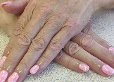 Glittery pink nails freshly done at Cassie's Beauty Therapy, Bude, England, GB.