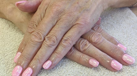 Glittery pink nails freshly done at Cassie's Beauty Therapy, Bude, England, GB.