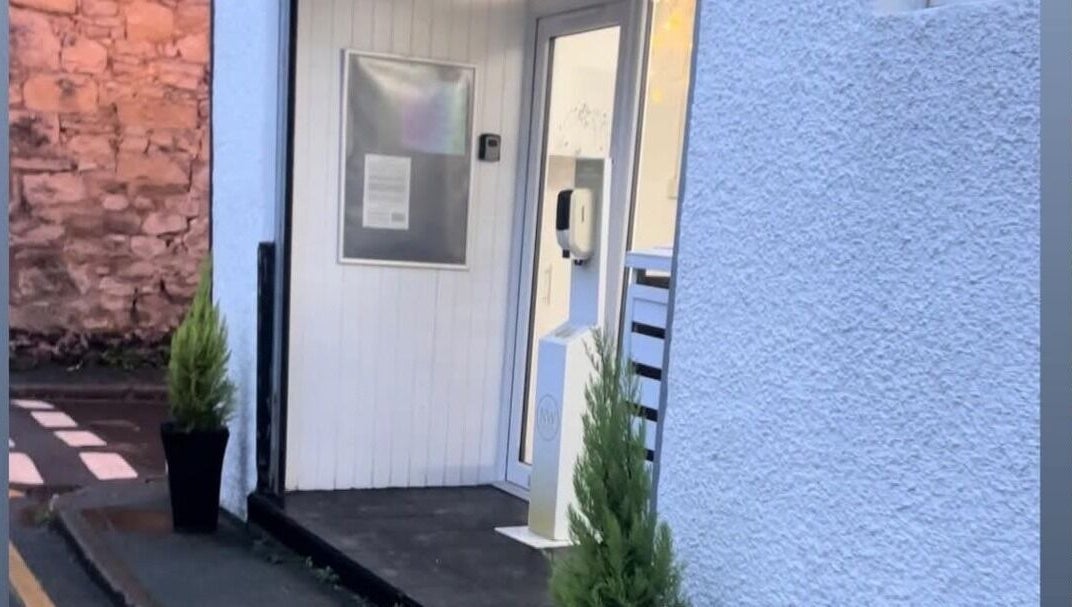 Entrance of Solace Head Spa in Llandudno, Wales, GB with elegant plant decor.